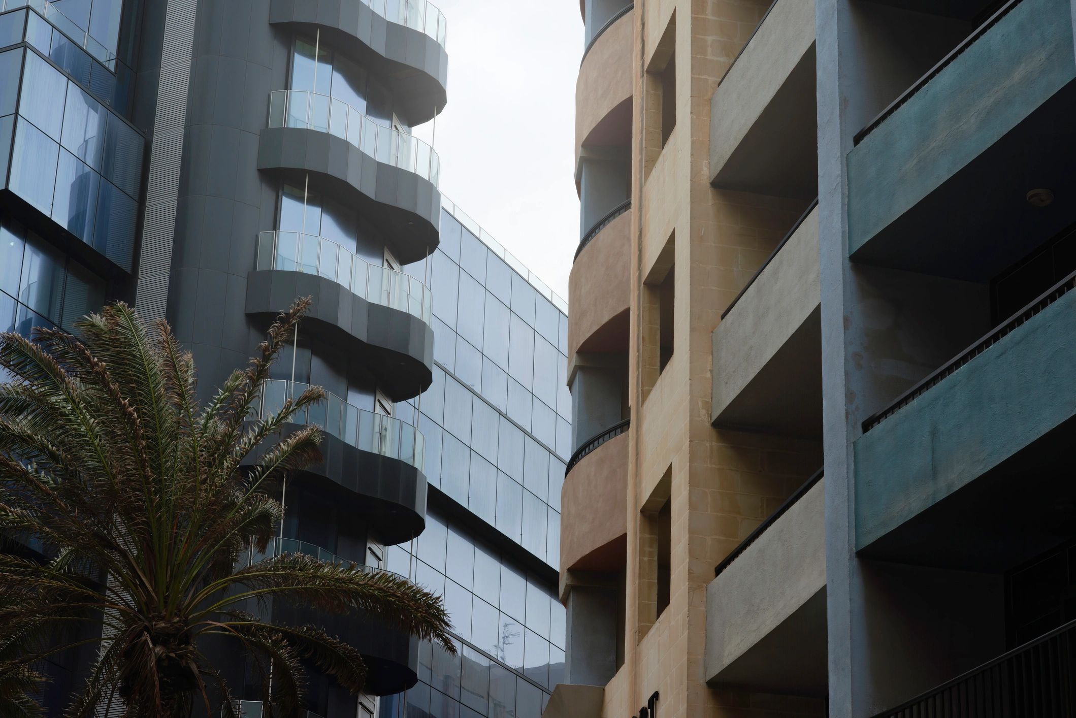 Concrete facade and glass building in Malta, symbolizing modern facility management and operational control.